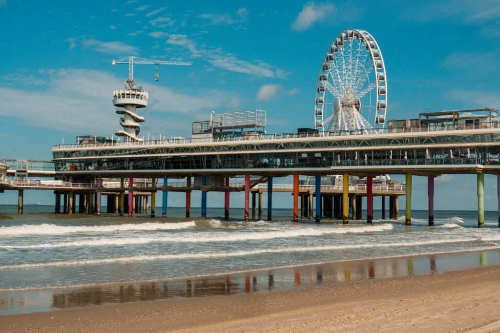 Molo w Scheveningen i diabelski młyn na tle błękitnego nieba